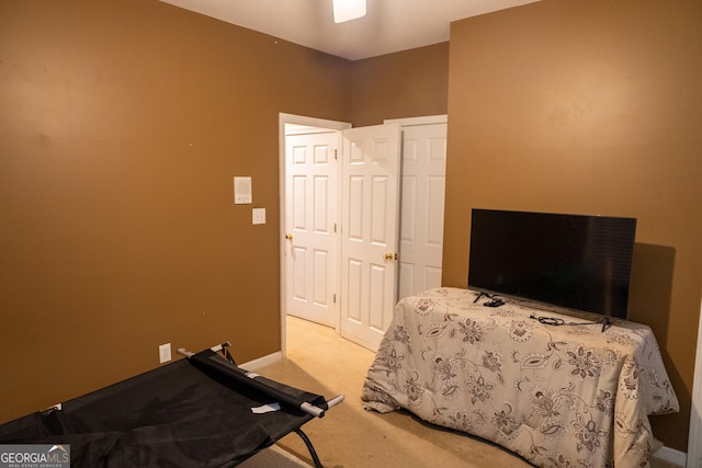 bedroom with baseboards and light colored carpet