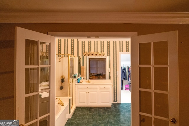 interior space with a tub to relax in, crown molding, and vanity