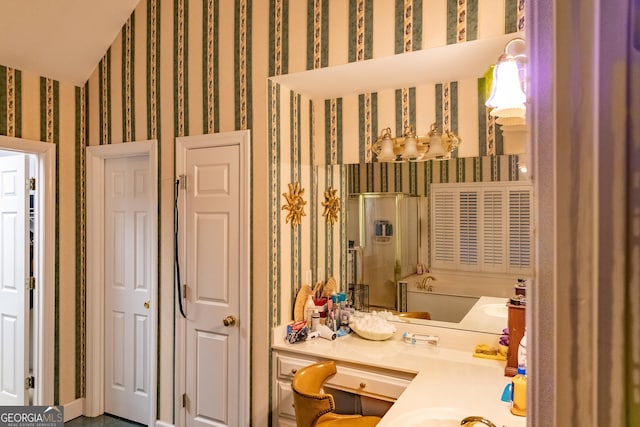 bathroom featuring a sink and wallpapered walls