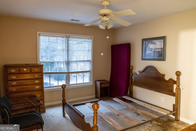 carpeted bedroom with a ceiling fan, visible vents, and baseboards