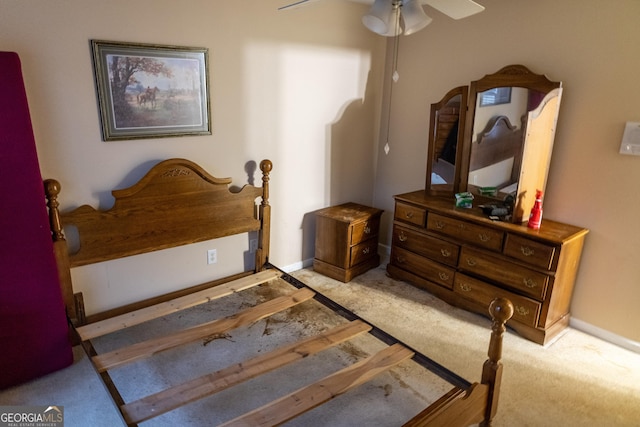 carpeted bedroom with baseboards and a ceiling fan