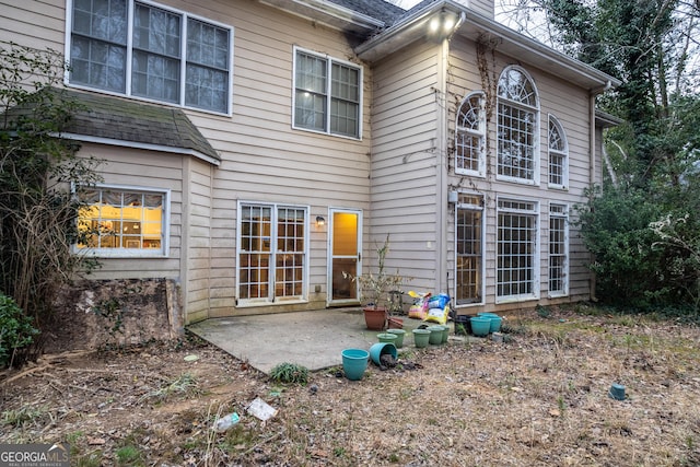 back of property with a patio and a chimney