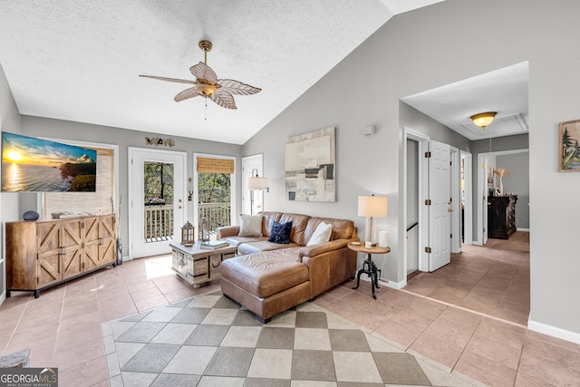 living room featuring light tile patterned floors, a ceiling fan, a textured ceiling, high vaulted ceiling, and baseboards