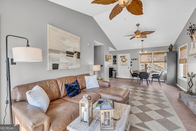 living area featuring vaulted ceiling, baseboards, and ceiling fan with notable chandelier