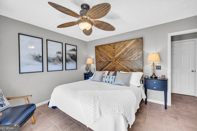 bedroom with tile patterned flooring, baseboards, and ceiling fan