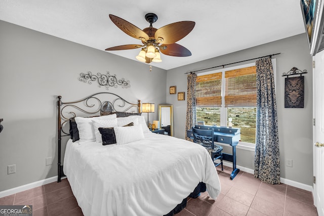 tiled bedroom featuring ceiling fan and baseboards