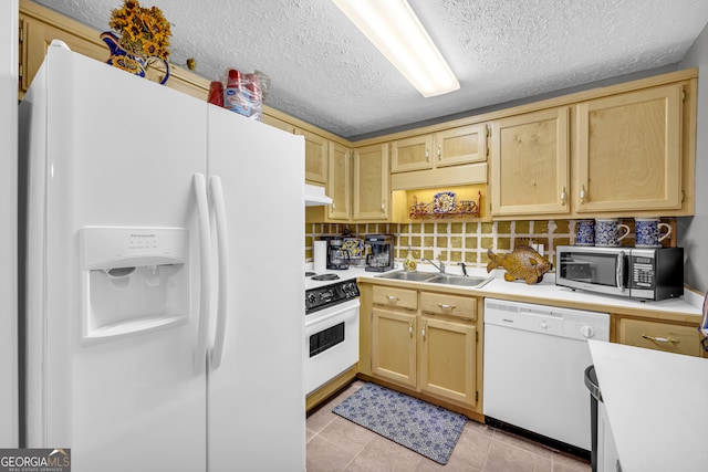 kitchen with light countertops, white appliances, a sink, and light brown cabinetry