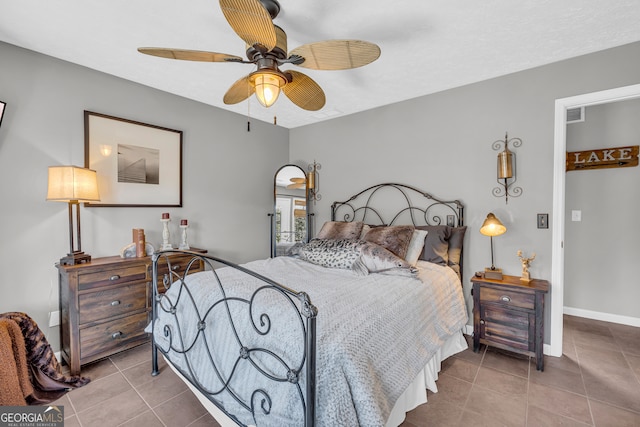 bedroom with a ceiling fan, tile patterned flooring, visible vents, and baseboards