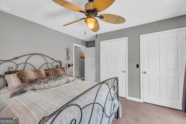 bedroom featuring ceiling fan, baseboards, and tile patterned floors