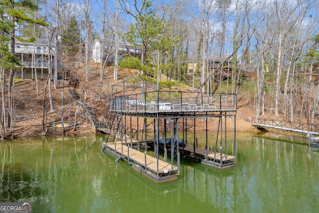 view of dock with a deck with water view