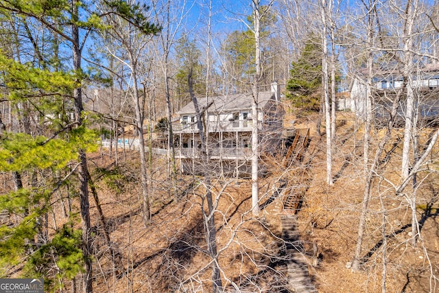 rear view of property featuring stairway