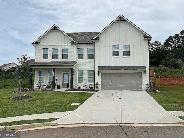 view of front of property featuring an attached garage, a front lawn, board and batten siding, and concrete driveway