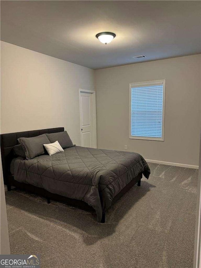 bedroom featuring carpet floors, baseboards, and visible vents