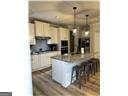 kitchen featuring cream cabinetry and a breakfast bar area