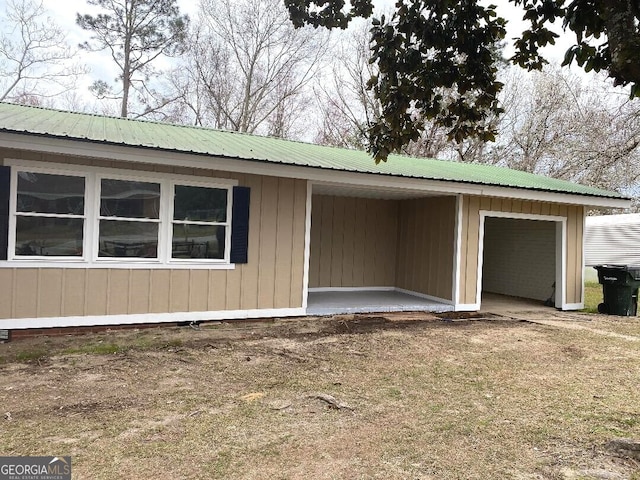 view of side of property with metal roof