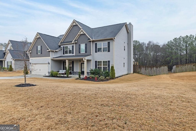 view of front of property featuring an attached garage, fence, concrete driveway, a chimney, and a front yard