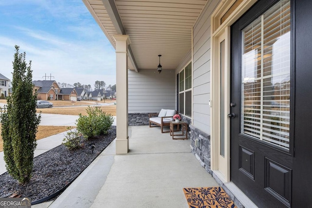 view of patio with a residential view and a porch