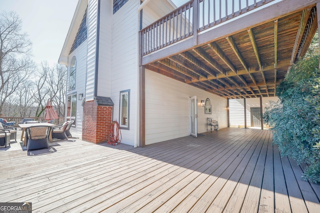 wooden terrace featuring outdoor dining space