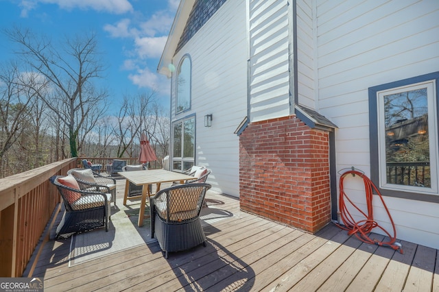 wooden terrace featuring outdoor dining area