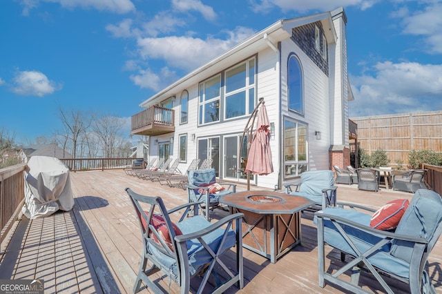 deck with fence and a fire pit