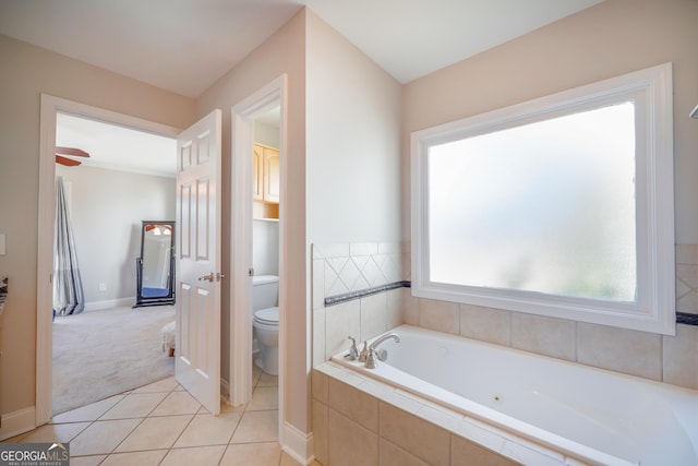 full bathroom featuring toilet, a garden tub, tile patterned flooring, and baseboards