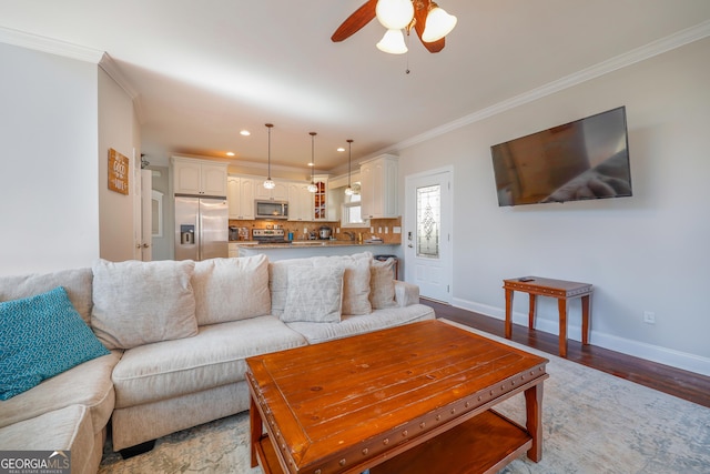 living area with recessed lighting, baseboards, crown molding, and wood finished floors