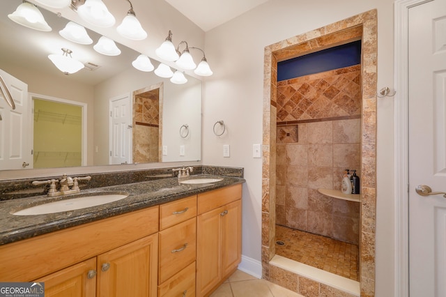 bathroom featuring tile patterned floors, double vanity, a sink, and a walk in shower