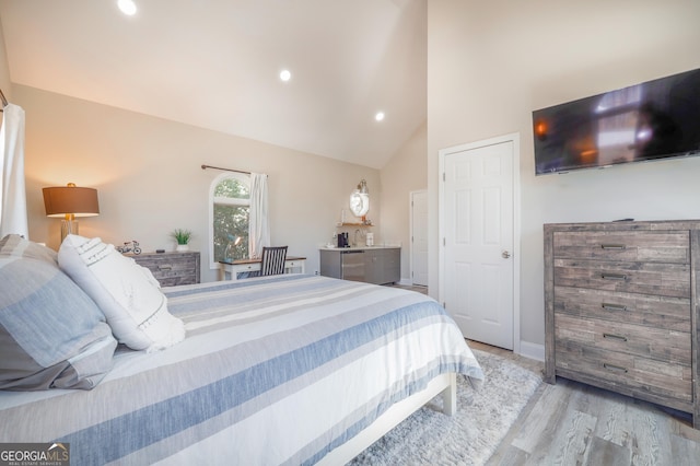 bedroom featuring high vaulted ceiling, recessed lighting, light wood-style flooring, and baseboards