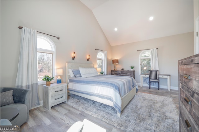 bedroom featuring high vaulted ceiling, light wood-type flooring, baseboards, and recessed lighting