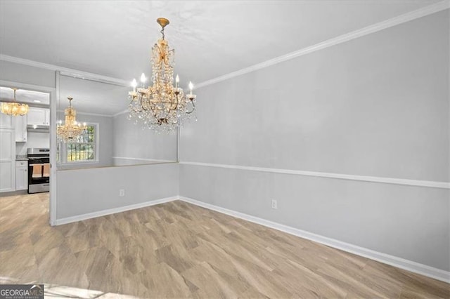 unfurnished dining area with crown molding, baseboards, light wood-style flooring, and an inviting chandelier