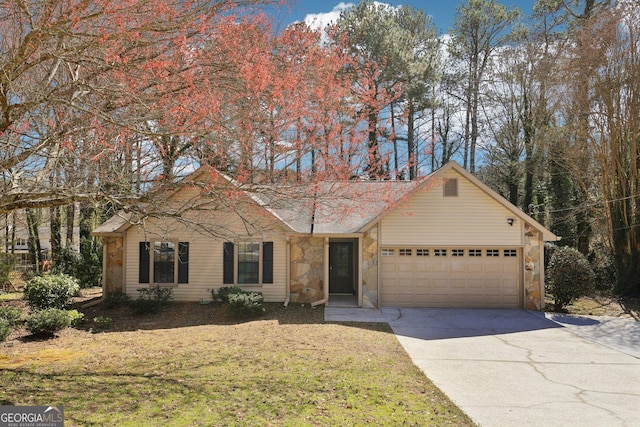 single story home with a front lawn, stone siding, an attached garage, and concrete driveway