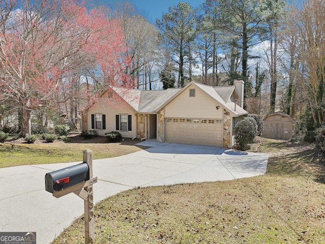 view of front of house featuring a chimney, concrete driveway, a front yard, a garage, and stone siding