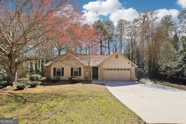 view of front of property with concrete driveway, stone siding, a front lawn, and an attached garage