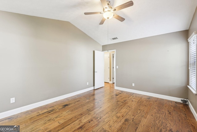 unfurnished room featuring lofted ceiling, ceiling fan, wood finished floors, and baseboards