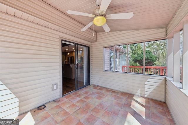 unfurnished sunroom featuring wood ceiling, vaulted ceiling, and a ceiling fan