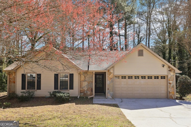 view of front of home with an attached garage, stone siding, and driveway