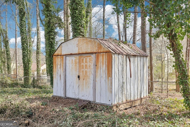 view of shed with fence