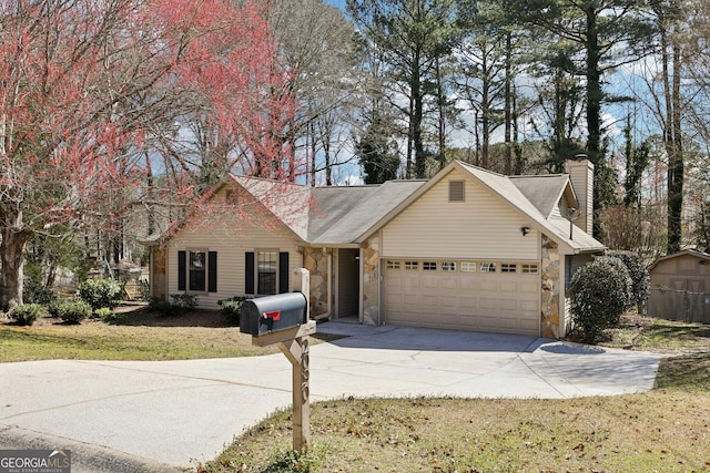 view of front of home with stone siding, driveway, a chimney, and an attached garage