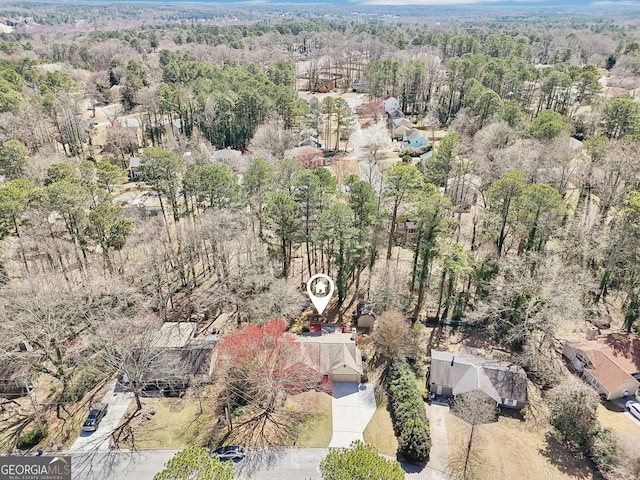 birds eye view of property with a forest view