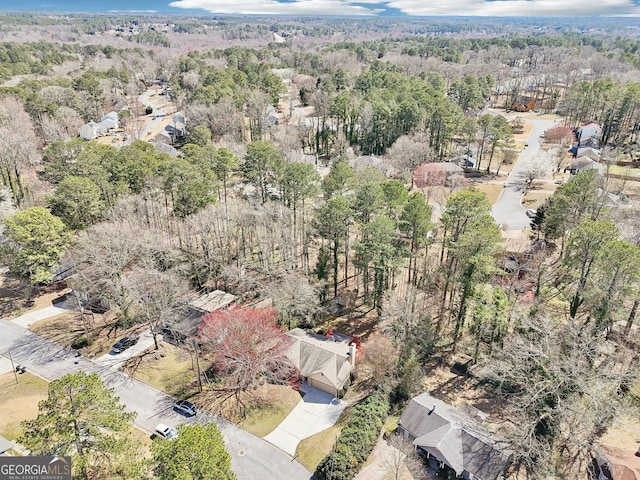 drone / aerial view featuring a wooded view