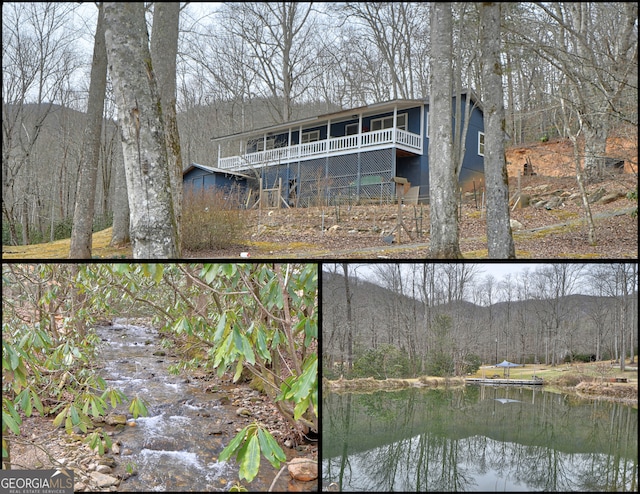 rear view of property with a water view, a view of trees, and stairs