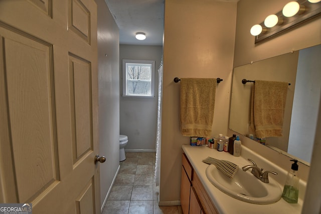 full bathroom featuring baseboards, vanity, toilet, and tile patterned floors