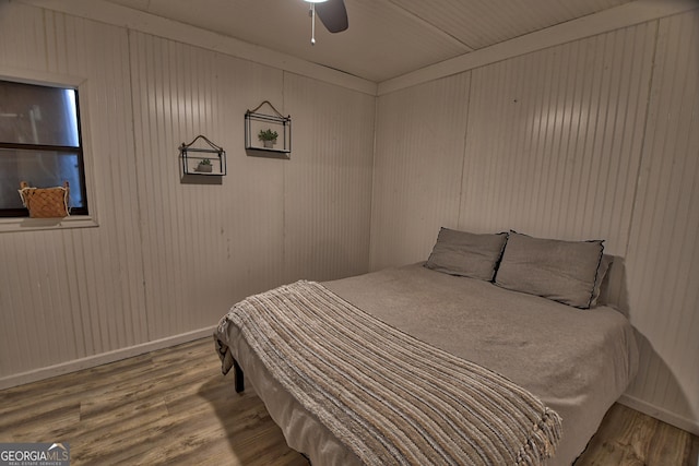 bedroom with baseboards, a ceiling fan, and wood finished floors