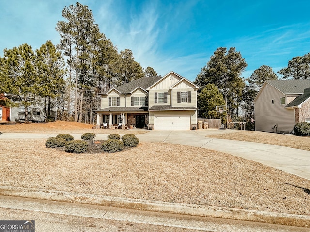 traditional home featuring board and batten siding, concrete driveway, and a garage