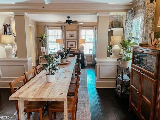 dining room with ornamental molding, dark wood-type flooring, and ornate columns