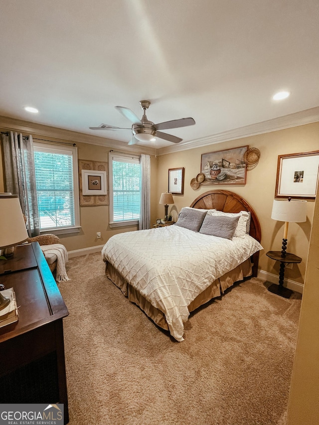 bedroom with a ceiling fan, carpet, baseboards, and crown molding