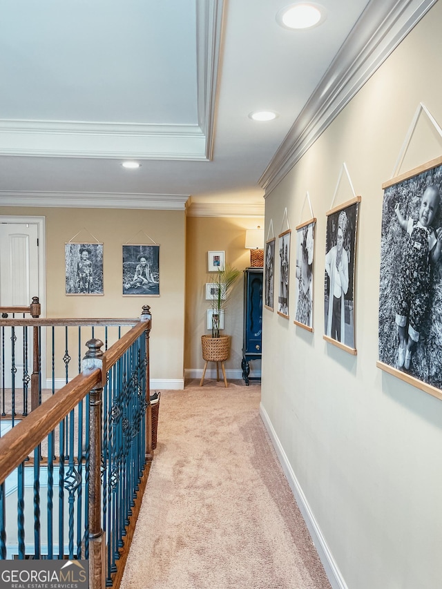 hall featuring carpet floors, crown molding, recessed lighting, an upstairs landing, and baseboards