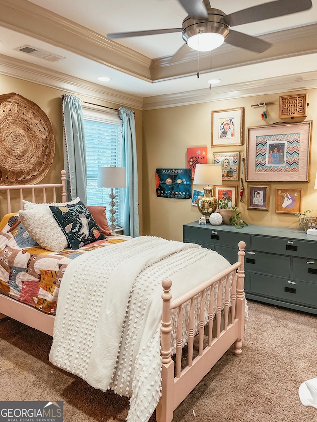 bedroom with carpet, a raised ceiling, visible vents, and crown molding