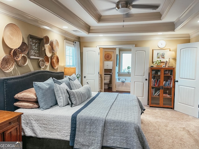 bedroom with visible vents, connected bathroom, a tray ceiling, carpet flooring, and recessed lighting