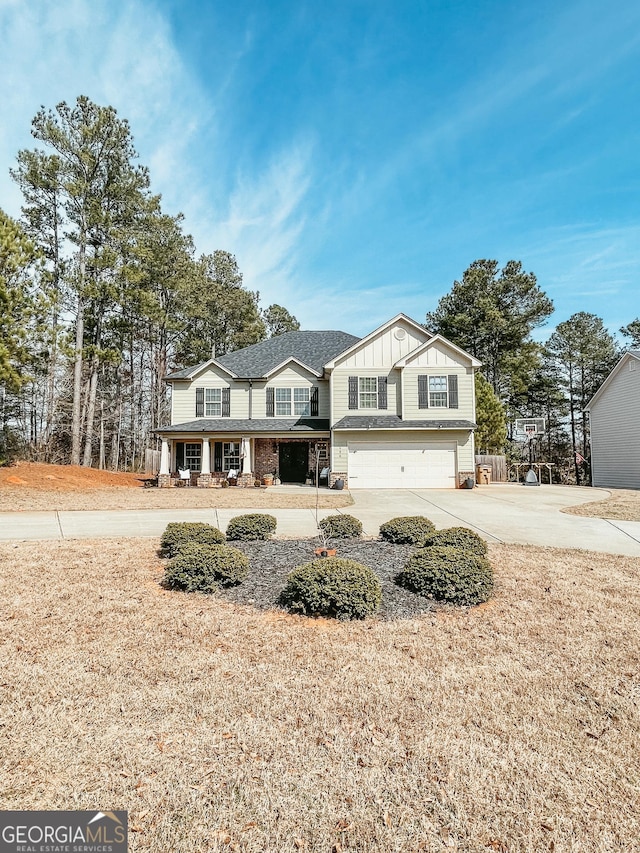 traditional-style house with driveway, board and batten siding, and an attached garage